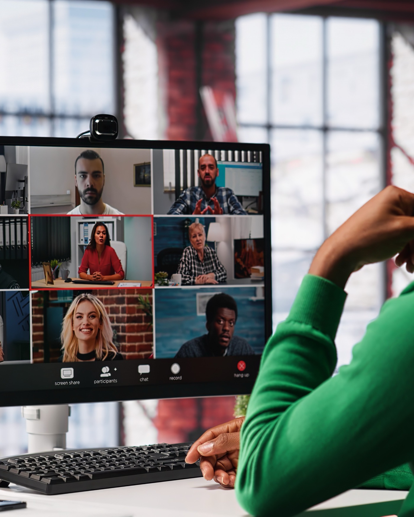 A business owner on a video call with a pod of people on screen