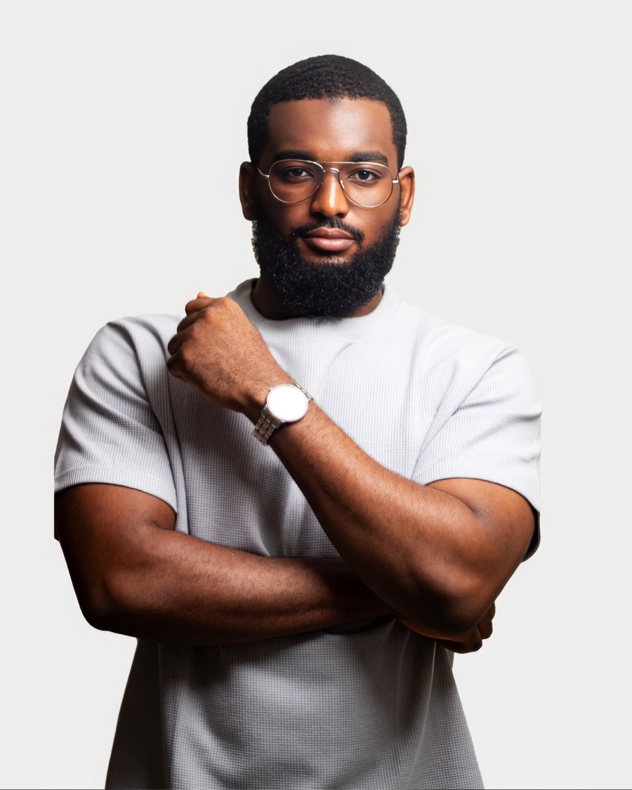 Omar Faruc in a grey T-shirt and glasses, arms crossed