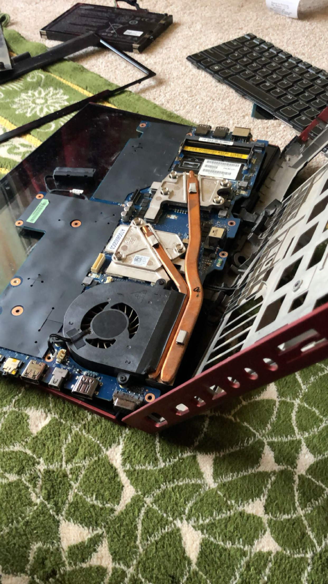A laptop taken apart on the floor