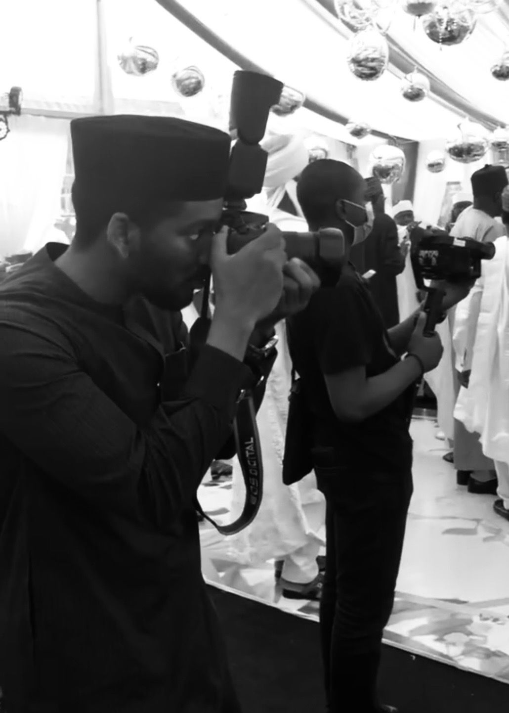 Omar shooting on a camera at an event